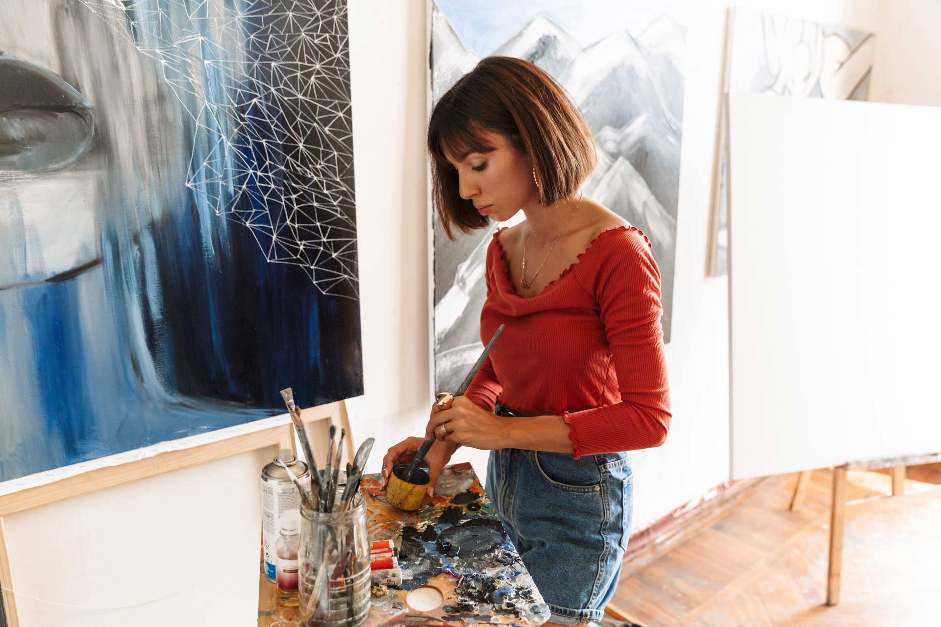 portrait-of-young-woman-using-painting-tools-while-AQRDSL3.jpg